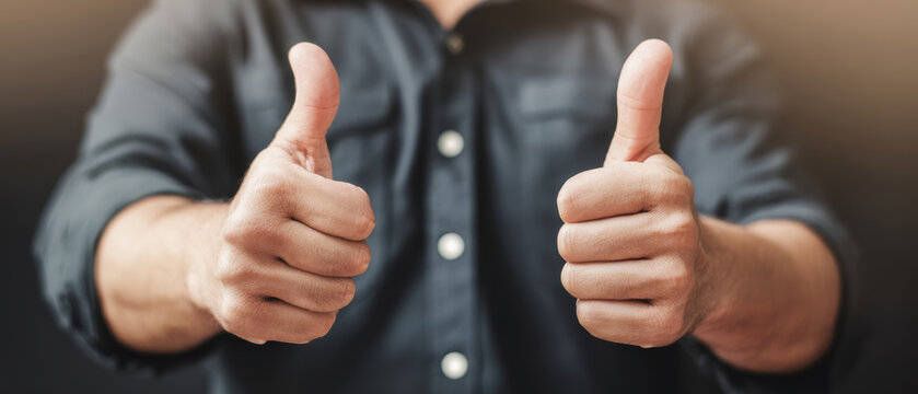 Thumb up hand gesture human hand approval sign positive symbol success concept casual shirt male person close up encouragement mood thumb up hand