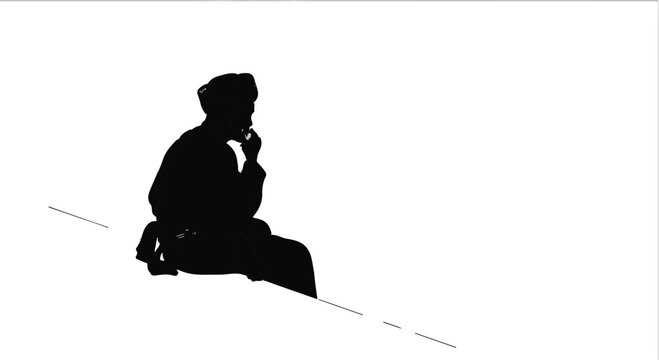 Silhouette of a person deep in thought, contemplating on a slope.