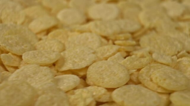 Macro rotating crunchy corn flakes breakfast texture background
