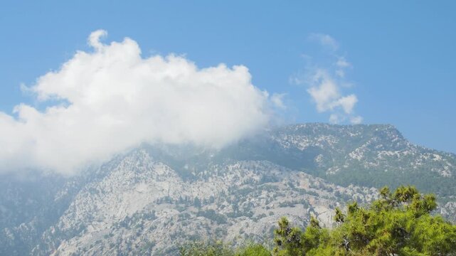 Clowds touching the summits of the Taurus Mountains in a peaceful Mediterranean summer landscape.
