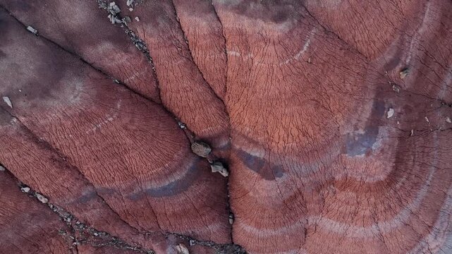 Aerial view of intricate textures and erosion patterns on red rock formations in the desert landscape of Hanksville, Utah, United States.