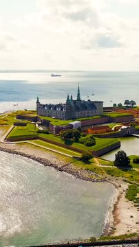 Vertical video. Helsingor, Denmark. A 16th-century castle with a banquet hall and royal chambers. The prototype of Elsinore Castle in the play Hamlet. Drone footage, Departure of the camera. Rich col