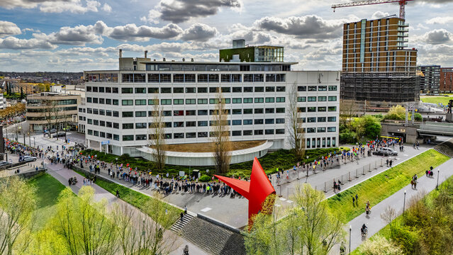 Aerial drone view of people running half marathon Venloop race in city, crowd runners on road racing sport competition, top-down view of athletes and spectators, Venlo, the Netherlands