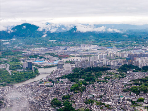 An aerial view captures the traditional architecture and scenic landscape of the Huizhou Ancient City in She County located within the Anhui province of China on a cloudy day