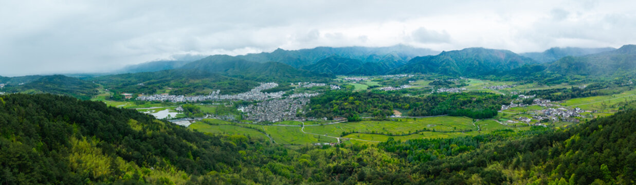 An aerial panoramic view shows the traditional architecture and natural landscape of the ancient Hongcun Village located in Yixian County of Anhui Province in China during a cloudy spring day