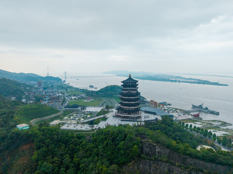 An aerial view captures the majestic Tower standing on a cliff overlooking the vast Yangtze River in the city of Jiujiang in China on a cloudy day