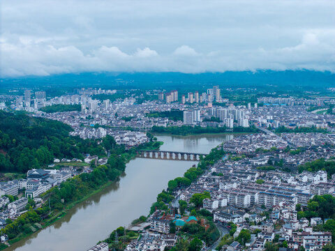 A high angle aerial view captures the scenic cityscape of Huizhou Ancient City located in She County of Anhui Province in China with a river flowing through the historic district