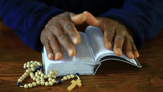 praying to God with hand's together on bible with people and white background stock video stock footage