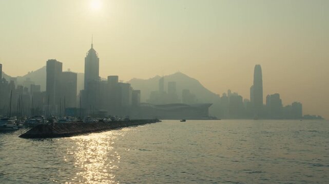 Hong Kong Victoria Harbour Skyline at Sunrise with Haze and IFC Tower Silhouette