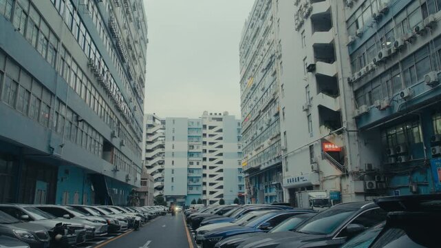 Shenzhen Factory District Narrow Street with Parked Cars Between Industrial Buildings