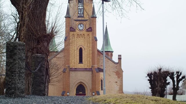 A static shot of Krager&oslash; Church in Telemark, Norway, on a cloudy day, neogothic architecture, no people