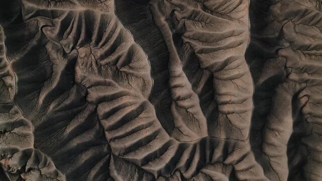 Aerial view of the intricate eroded ridges and deep shadows of the Factory Butte badlands Wayne County, Utah, United States.