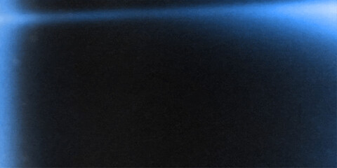 Naklejka premium Soft glowing light in the dark night air over a textured black surface background