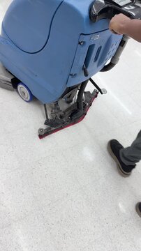 Industrial Floor Scrubber Machine Cleaning White Tiled Airport Floor