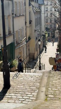 Backpacked traveler descending paris cobblestone steps