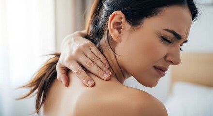 Fototapeta premium Woman Experiencing Neck Pain and Discomfort While Massaging Her Shoulder.