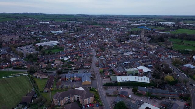 Aerial view of the historic market town of Oakham with its traditional brick buildings, winding streets, and surrounding green fields in Oakham, England, United Kingdom.