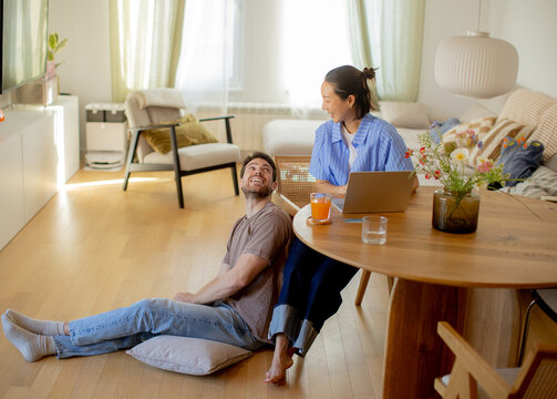 Couple enjoys a cozy morning together in a sunlit living room