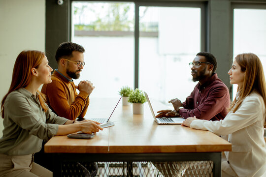 Couple enjoying conversation and coffee in a cozy modern cafe setting