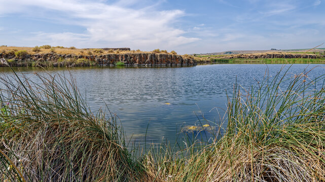 Panorama of the basalt formations across Hutchinson Lake near Othello, Washington, USA