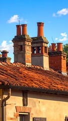 Naklejka premium Tile rooftops with brick chimneys reaching towards a blue sky
