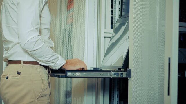 IT Engineer Working With Server Rack Console In Data Center. Technician Configuring Network Hardware