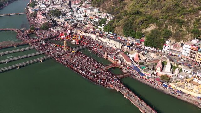 Aerial view of massive crowd at har ki pauri haridwar for hindu festival, 6k footage.