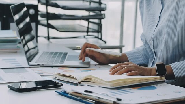 Business woman accountant working in office checking financial accounts and allocating company budgets.