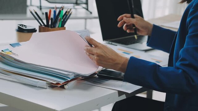 Business woman accountant working in office checking financial accounts and allocating company budgets.