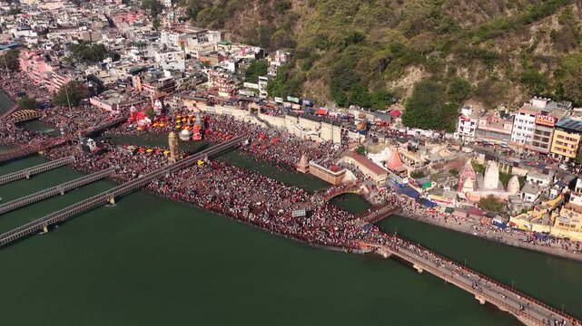 Massive crowd gather at har ki pauri haridwar for hindu ritual and holy bath, aerial view of kumbh mela at uttarakhand.