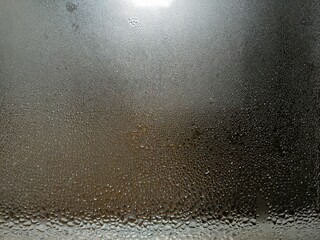 Obraz premium Foggy window, water on glass, texture of water drops on glass