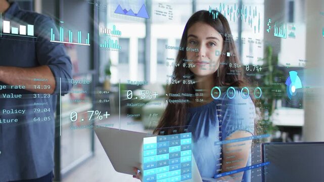 Woman with laptop scrolling data biz AR charts updating around laptop as team talking she smiling