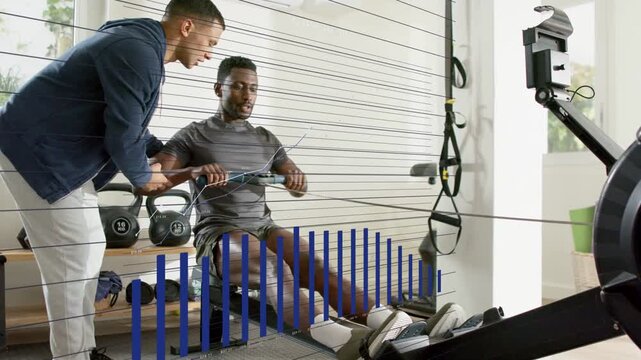 Fitness trainer coaching athlete starting drive on rower, blue bars rising on screen fixing form