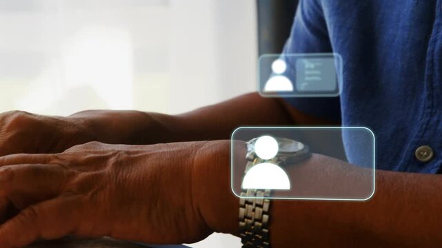 Senior man typing on keyboard and sorting contacts, tech profile icons appearing, stacking at wrist