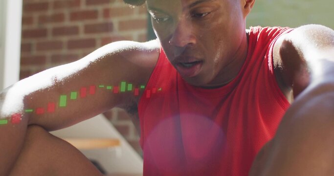 Leaning male athlete resting at courtyard, wearing red tank top with left arm candlestick overlay