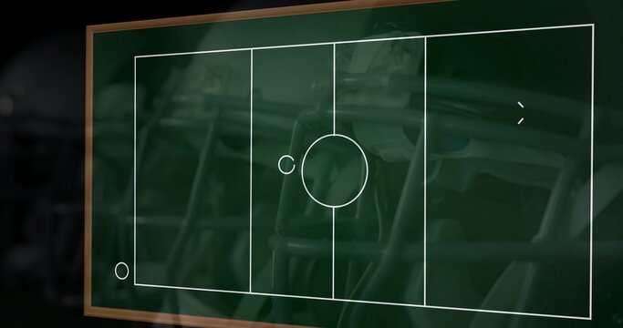 Displaying wood-frame green chalkboard with chalk sports diagram and ticks in classroom reflections