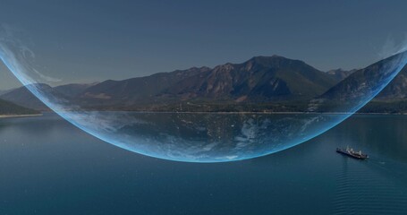 Fototapeta premium Spanning large blue dome crossing horizon at mountain coast, with cargo ship leaving V wake