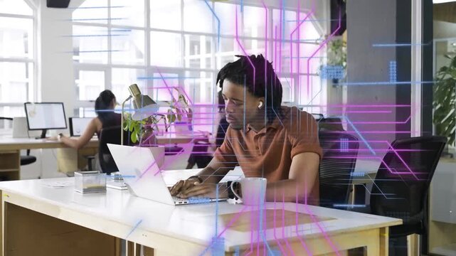 Man typing on laptop in office, causing holographic code and magenta grids aiding data analysis