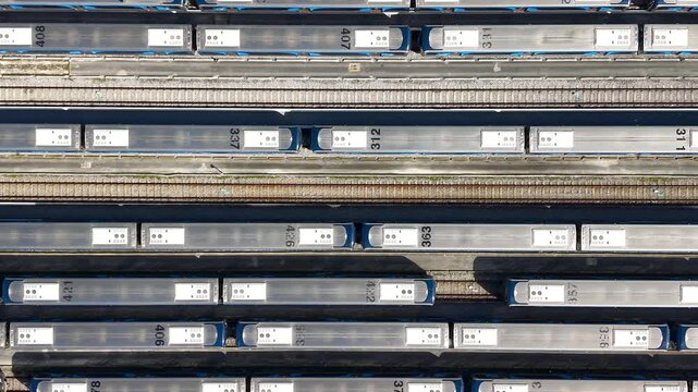 Top down aerial view of trains parked on multiple railway tracks