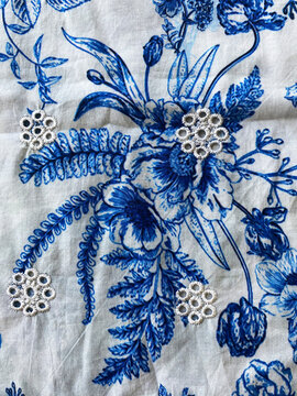 Close-Up White Thread Floral Cutwork Embroidery on Blue Printed Cotton Fabric