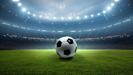 Soccer ball on the pitch with national flags in stadium at night. An imaginary stadium is modelled and rendered. © efks