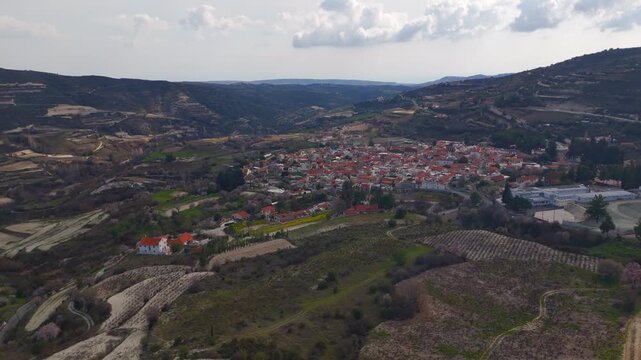 Aerial Drone Tilt Up Reveal of Historic Omodos Village and Mediterranean Hillside in Cyprus