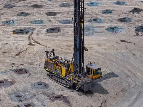 Drilling and blasting process with heavy machinery such as surface rotary drills