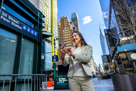 Businesswoman using smartphone near 34 street penn station