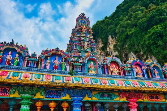 Batu Caves, Kuala Lumpur, July 21, 2023: New view with colourful staircase at Murugan Temple Batu Caves has become a new tourist attraction in Malaysia. This was on a hot cloudy day during wet season.