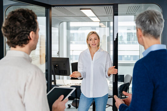 Business meeting in a modern office with a woman leading the discussion