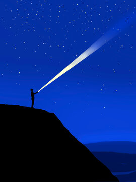 Silhouette shining a light beam into the starry night sky
