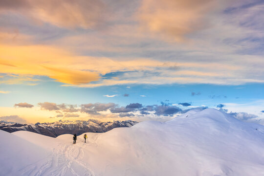 Winter sport on a snowy mountain ridge at sunset