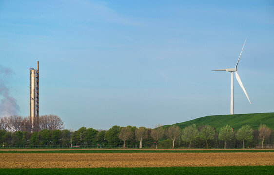Contrast of wind turbine and fertilizer factory in the Netherlands