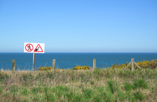 Warning sign at Pointe du Hoc cliff in Normandy France